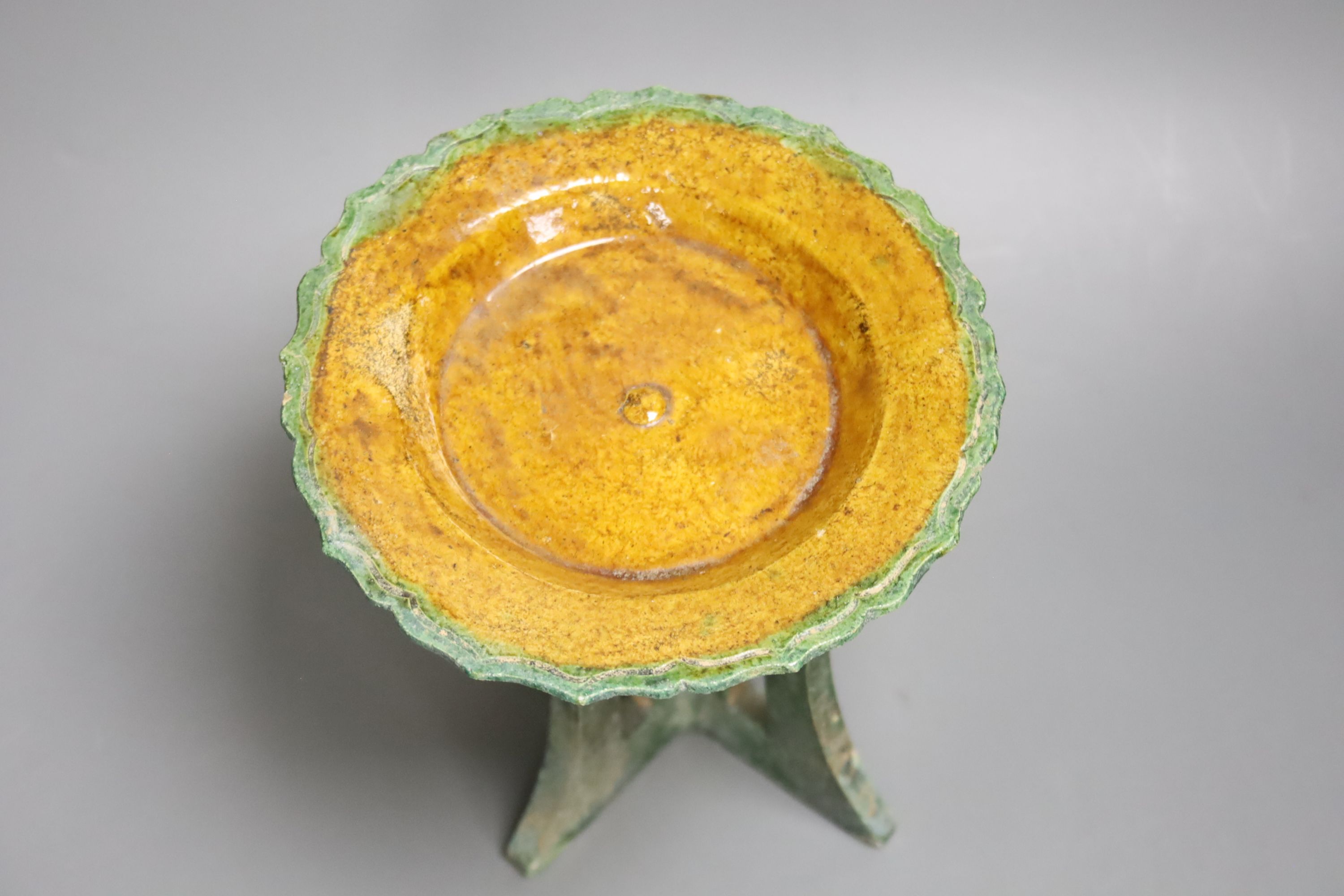 A Ming offering dish, on pottery stand